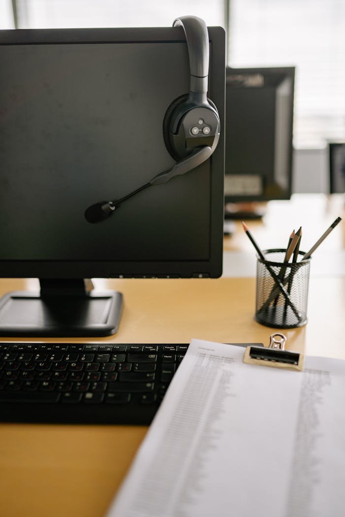Crafting Captivating Headlines: Your awesome post title goes here Clean and organized workspace featuring a computer monitor with headset in a modern office setting.